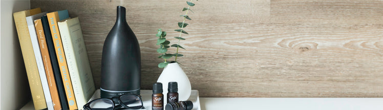 An aroma om diffuser next to a stack of books