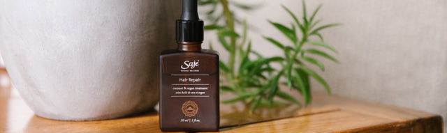 Saje Hair Repair Treatment with Rosemary Oil placed on countertop