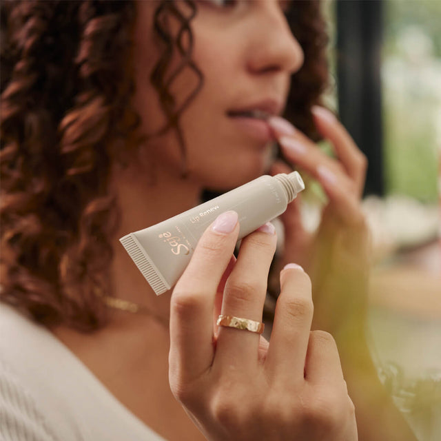 Woman applying lip renew overnight mask to lips