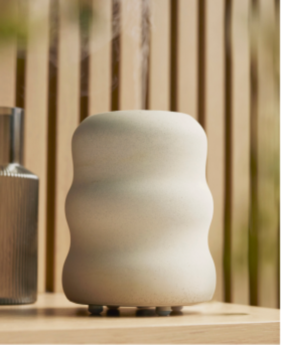 Aroma Wave diffuser styled on a wood table. 