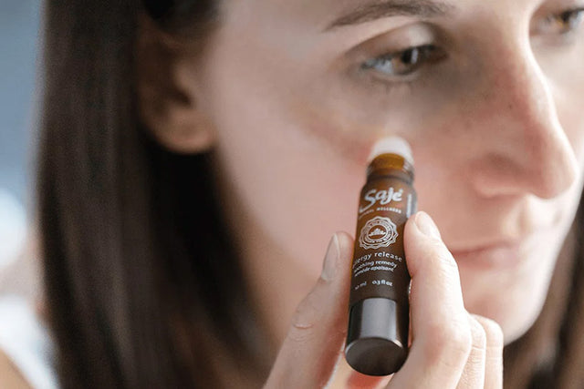 Women applying roll-on under her eyes