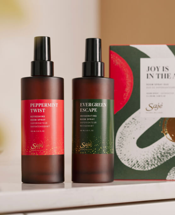 The Joy is in the Air Room Spray Duo and packaging rests on a marble countertop.