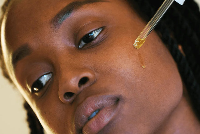 woman applying face oil