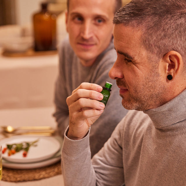 A man smelling a diffuser blend from the bottle