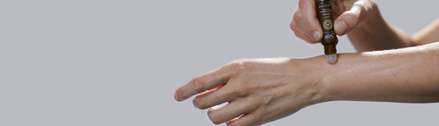 Pain release roll-on being applied to arm
