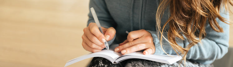 A woman writing in her journal 