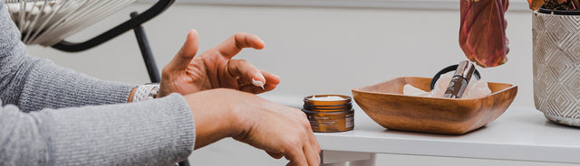A person applying Saje Body butter onto their hand