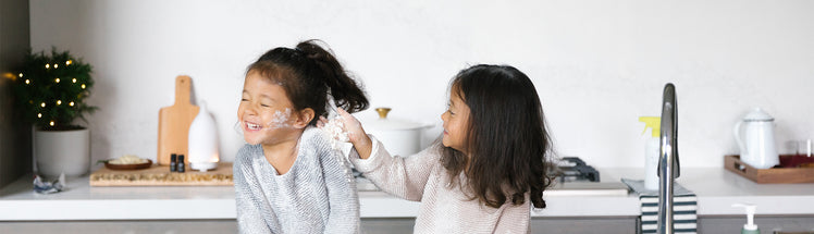 two girls in the kitchen playing with saje foaming hand soap