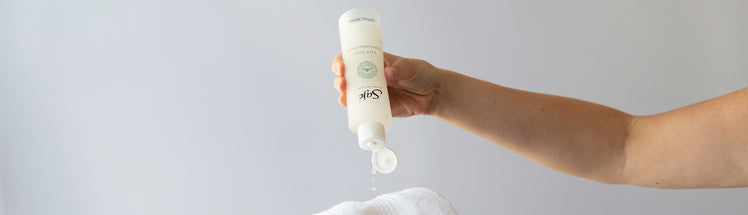 Saje Bare Face makeup remover being dispensed onto a white face towel