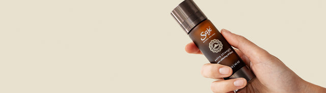 A person holding extra strength pain relieving oil blend