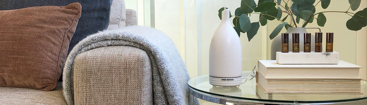 Aroma Om Diffuser placed on side table beside couch 