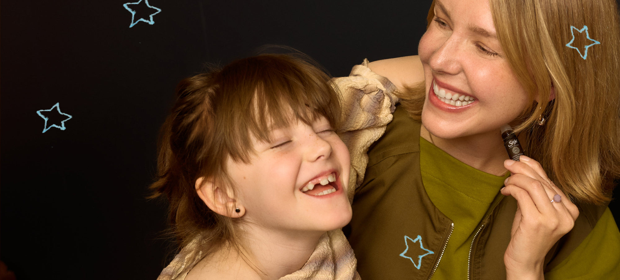 Mom and Child laughing and applying peppermint halo roll on 