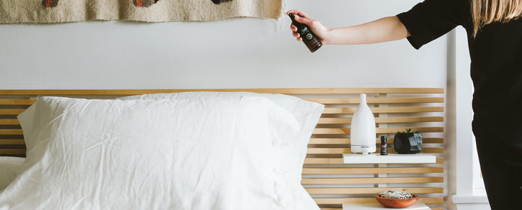 A person spraying sweet sheets spray onto their pillow