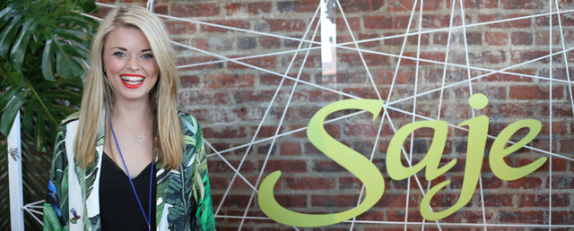 Kiara LeBlanc standing in front of a Saje sign