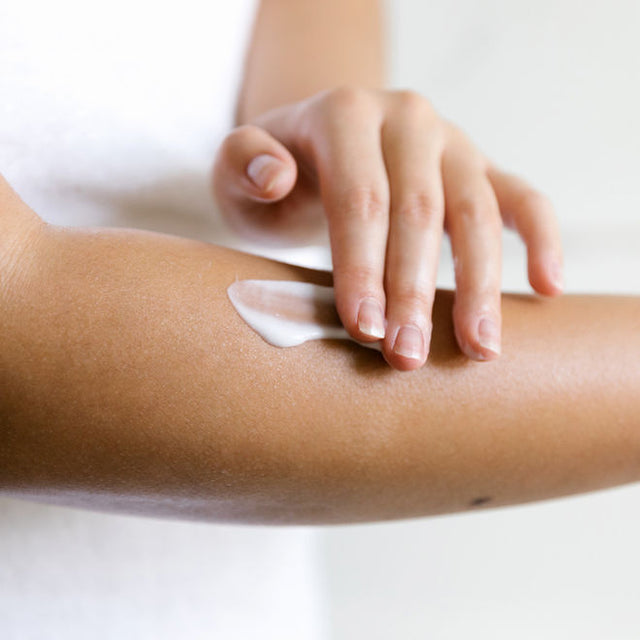 A person applying Tingle mint invigorating body lotion into their arm