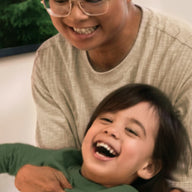 A close-up shot of a father and son play-fighting.