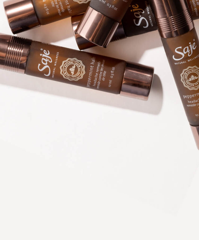 Stack of Peppermint Halo Roll-on bottles on a white background.