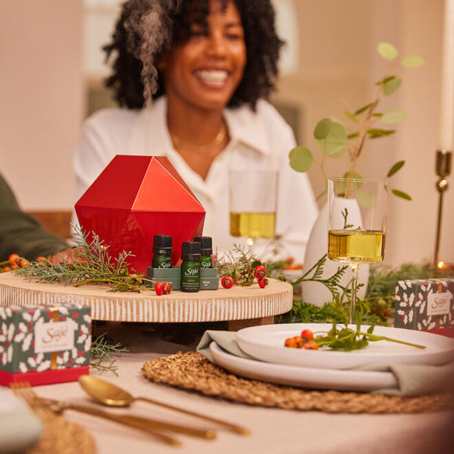 Aroma (be) free ruby red geometric diffuser on festive table with a woman smiling behind