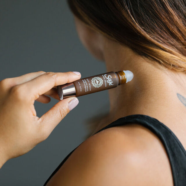 Pain release roll-on being applied to pulse point