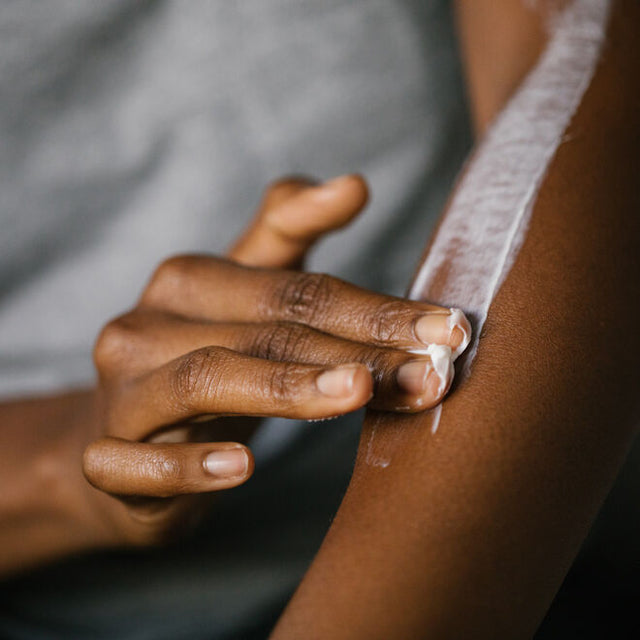A person applying Tantra Sensuous coconut and shea body butter to their forearm 