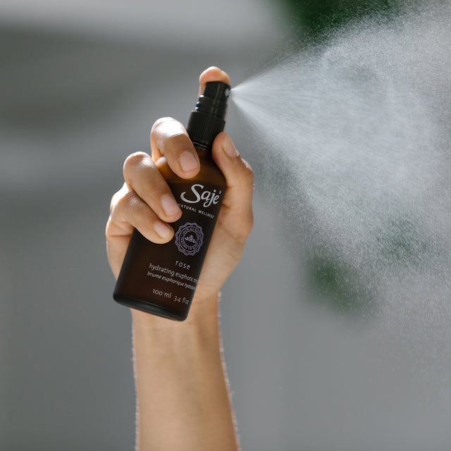A person spraying Rose Hydrating Euphoric Mist 100ml 