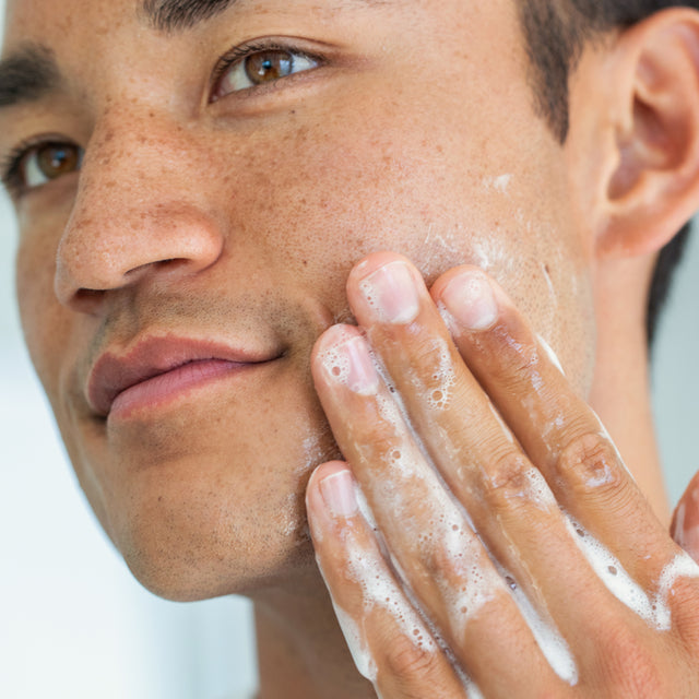 person applying Claritea gel cleanser on face