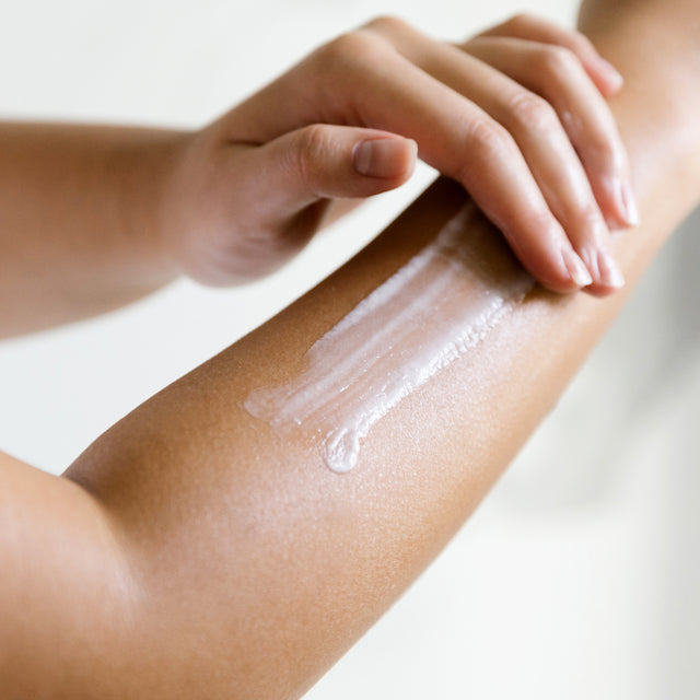 person applying Liquid Sunshine Hand Cream on arm