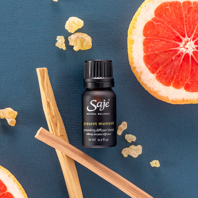 Present moment grounding diffuser blend 10ml placed with grapefruit, sandalwood, and vetiver 